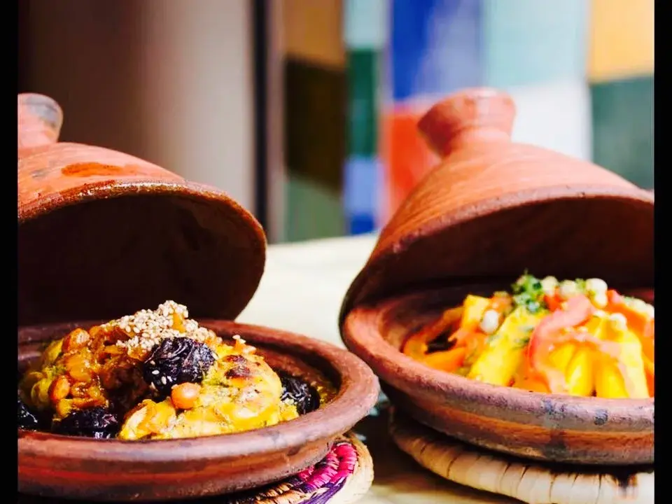 Two Moroccan tagines served in terracotta dishes